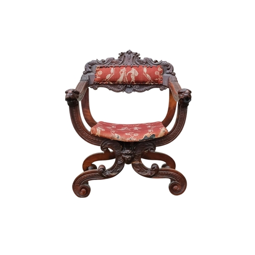 942 - A 17th century style continental walnut Savonarola chair - with carved lion mask finials.