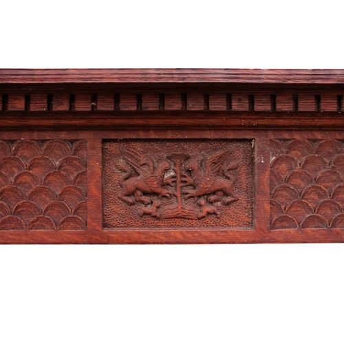 944 - A 17th century style oak hanging shelf - the carved cornice above four shelves with pierced end supp... 