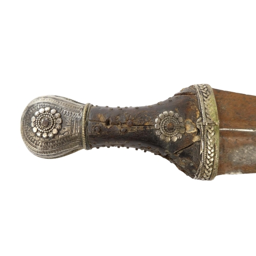 95 - A Middle Eastern Khanjar - the hardwood handle with copper studs and white metal fittings, the curve... 