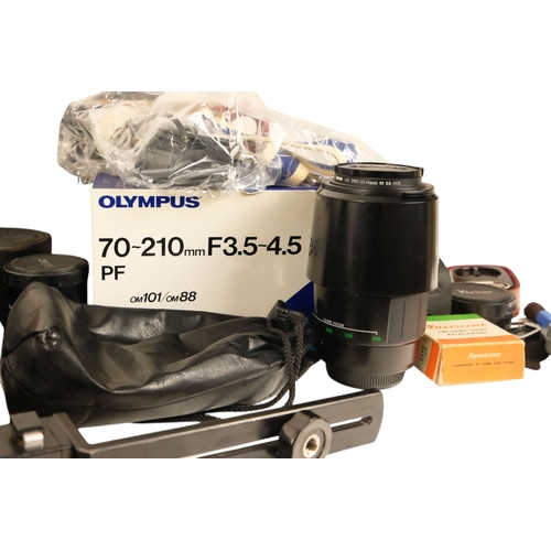 106 - A Olympus OM101 35mm film camera - boxed, together with two further OM1 camera's and a quantity of l... 