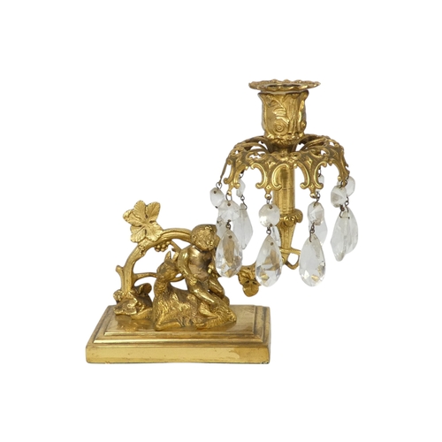 109 - A pair of early 20th century cast brass candlesticks - the foliate sconces on a grape-vine support a... 