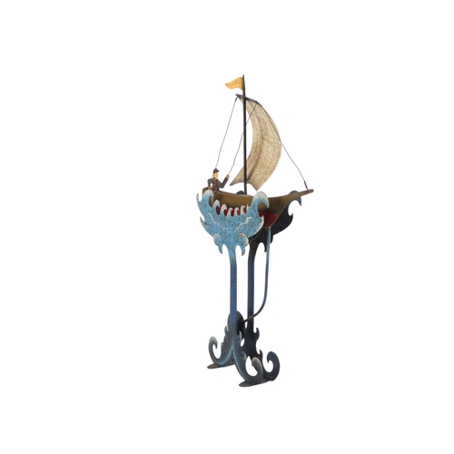 11 - A 20th/21st century weighted automaton vessel - polychrome painted in the form of a sailing boat wit... 