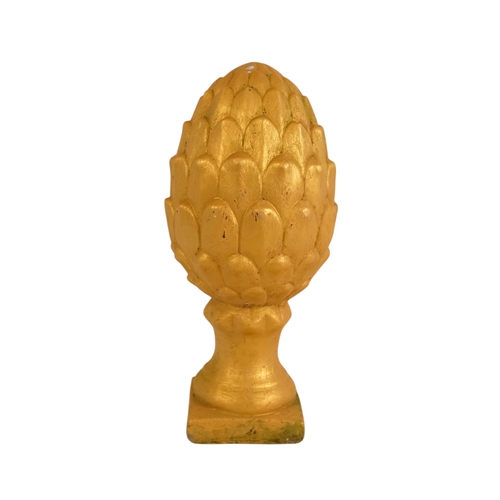 110 - A pair of cast stone finials - modelled in the form of pineapples and gilt decorated, 31cm high (2)