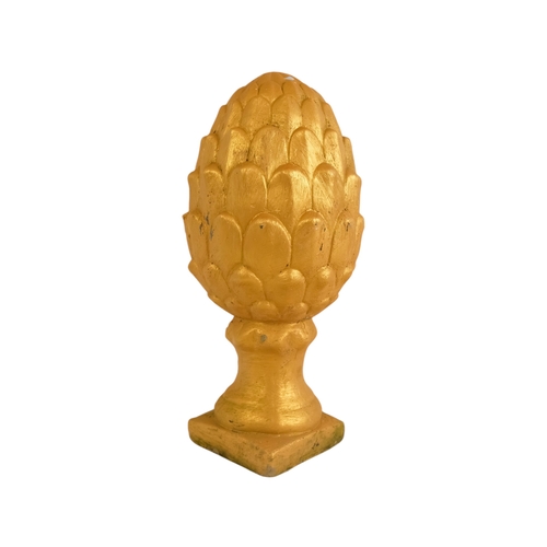 110 - A pair of cast stone finials - modelled in the form of pineapples and gilt decorated, 31cm high (2)