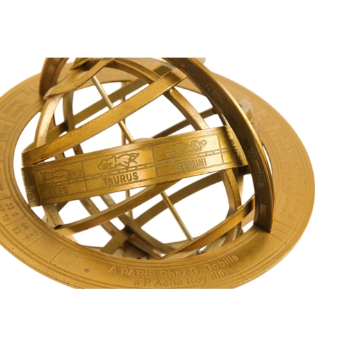 112 - A brass armillary globe - with a band engraved with signs of the zodiac, 27cm high