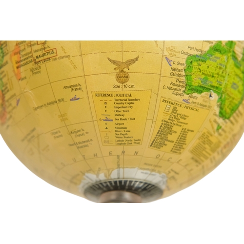 113 - A contemporary globe - surmounted by an aircraft, 25cm high