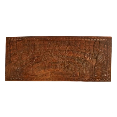 117 - An African fetish - wraped in cloth with twine, 42cm long, together with a carved hardwood palque, d... 