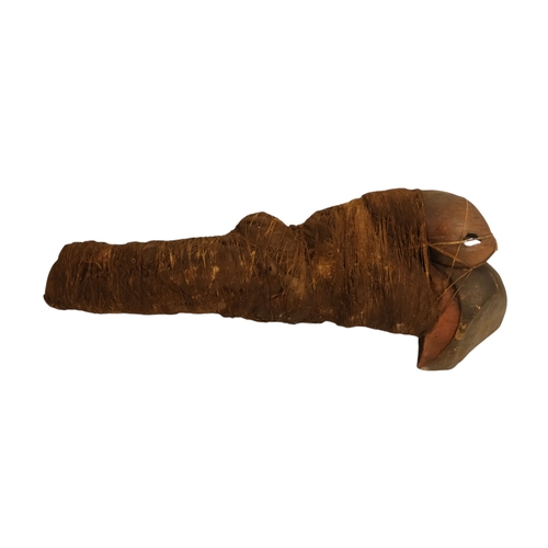 117 - An African fetish - wraped in cloth with twine, 42cm long, together with a carved hardwood palque, d... 