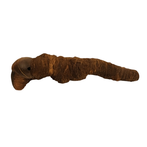 117 - An African fetish - wraped in cloth with twine, 42cm long, together with a carved hardwood palque, d... 