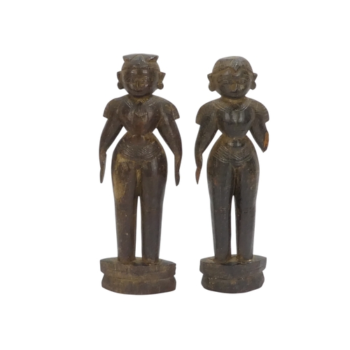 23 - A pair of 19th century African carved hardwood figures - male and female, 23cm high.