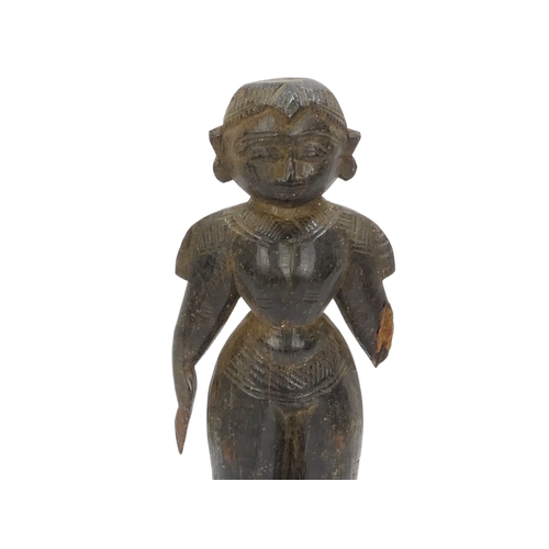 23 - A pair of 19th century African carved hardwood figures - male and female, 23cm high.