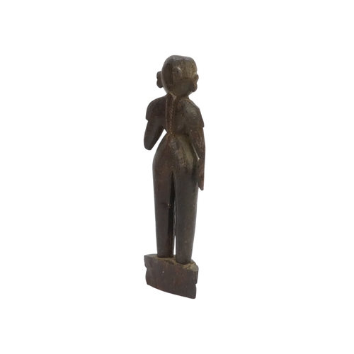 23 - A pair of 19th century African carved hardwood figures - male and female, 23cm high.