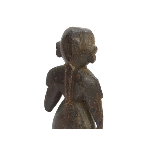 23 - A pair of 19th century African carved hardwood figures - male and female, 23cm high.