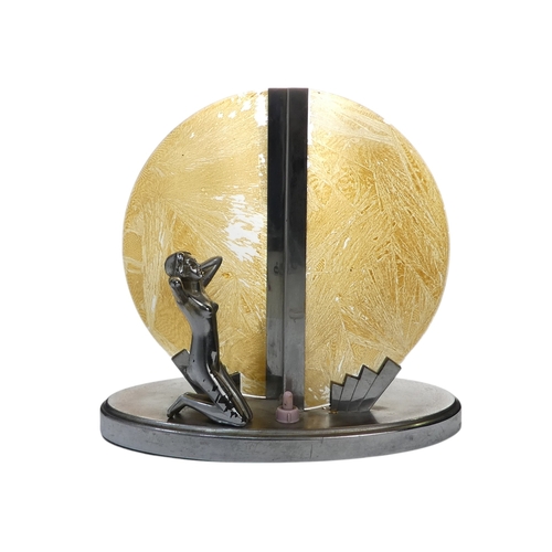 26 - An Art Deco chrome and glass table lamp - modelled with a kneeling figure before a yellow disc, 22cm... 