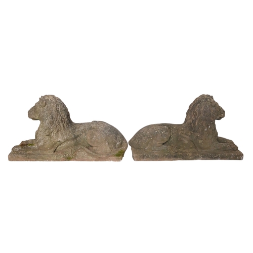 41 - A pair of reconstituted stone lions - recumbent, 73cm wide. (2)