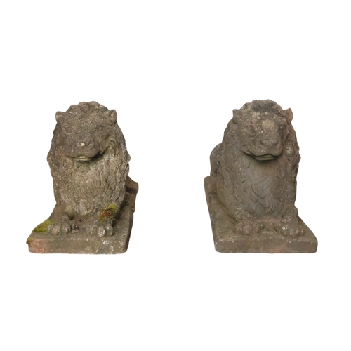 41 - A pair of reconstituted stone lions - recumbent, 73cm wide. (2)