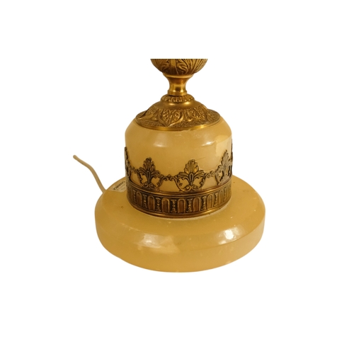 42 - A pair of alabaster and gilt metal table lamps - with twin handles and foliate castings, 58cm high. ... 