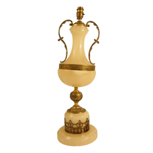 42 - A pair of alabaster and gilt metal table lamps - with twin handles and foliate castings, 58cm high. ... 