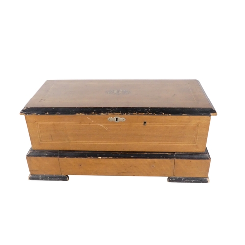 57 - A late 19th century cylinder music box - the rectangular walnut case with stringing and stencilled d... 