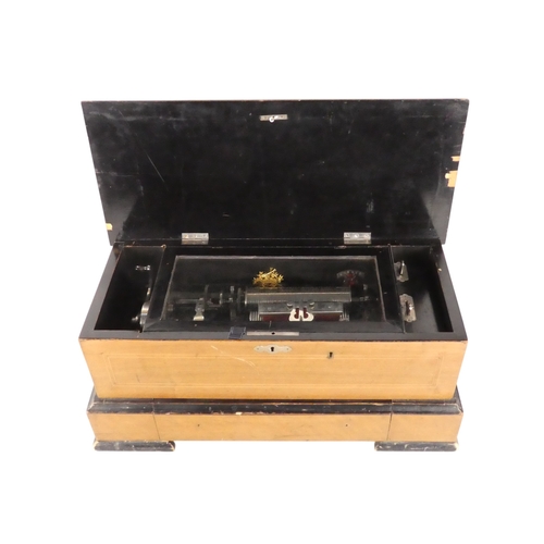 57 - A late 19th century cylinder music box - the rectangular walnut case with stringing and stencilled d... 