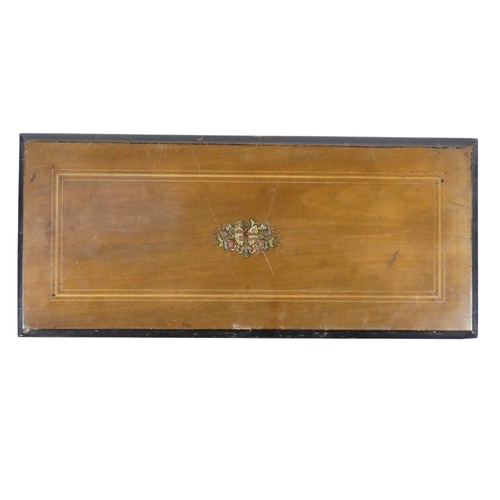 57 - A late 19th century cylinder music box - the rectangular walnut case with stringing and stencilled d... 