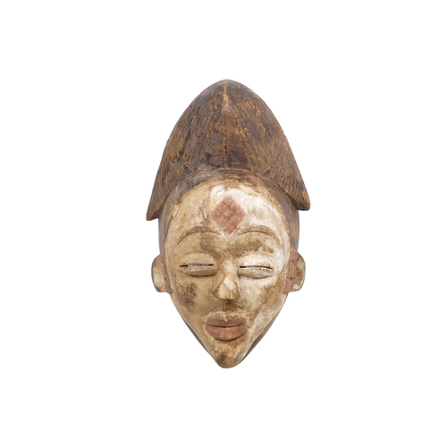 69 - A carved hardwood African mask - polychrome painted with a white face and terracotta flashes, 30cm h... 