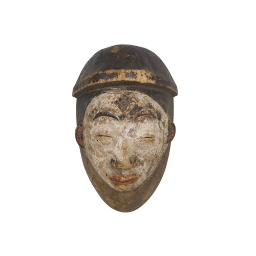 73 - A carved hardwood African mask - with white face, 33cm high