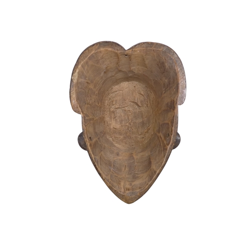 74 - A carved hardwood African mask - with an accentuated hair arrangment and white face, 31cm high