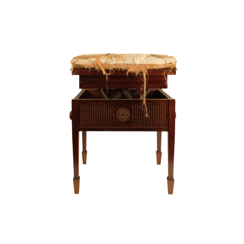 921 - An Edwardian mahogany piano stool - with an upholstered hinged seat above a fluted frieze, on square... 