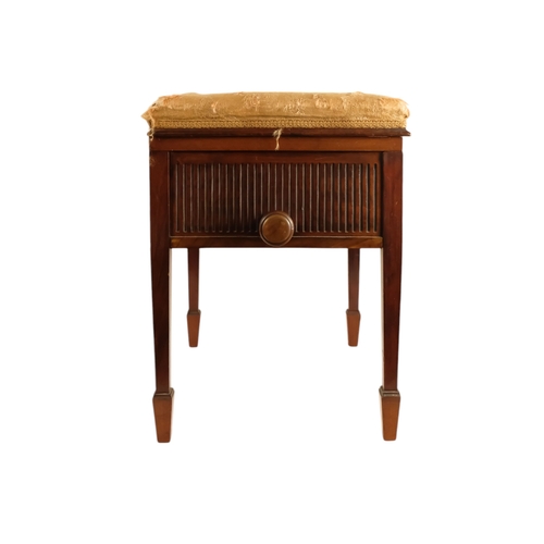 921 - An Edwardian mahogany piano stool - with an upholstered hinged seat above a fluted frieze, on square... 