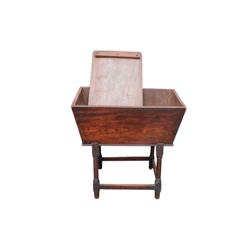 923 - An 18th century elm dough bin - of typical tapering rectangular form and raised on square and turned... 