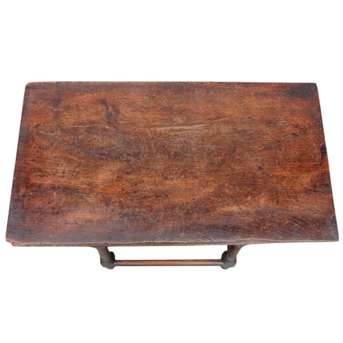 923 - An 18th century elm dough bin - of typical tapering rectangular form and raised on square and turned... 