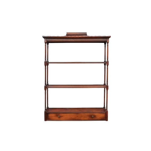 925 - A Regency style mahogany hanging wall shelf - with a pagoda canopy above three shelves with turned s... 