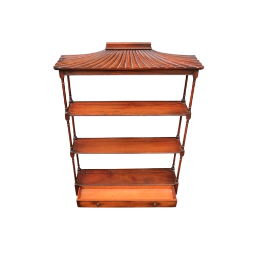 925 - A Regency style mahogany hanging wall shelf - with a pagoda canopy above three shelves with turned s... 