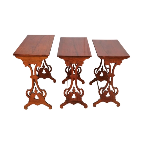 926 - A nest of three William IV rosewood tables - with rectangular tops and pierced vase shaped end suppo... 