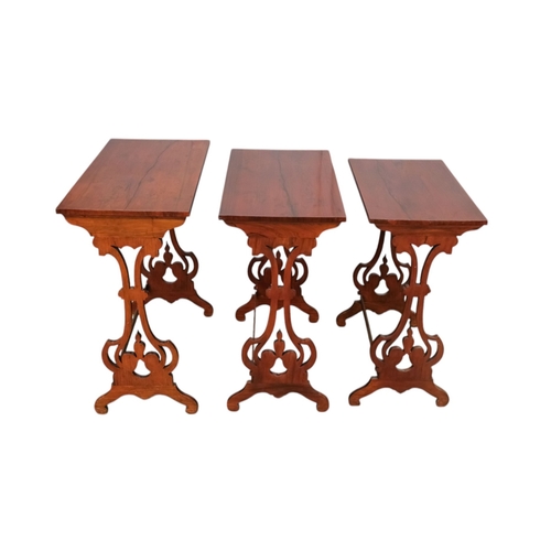 926 - A nest of three William IV rosewood tables - with rectangular tops and pierced vase shaped end suppo... 