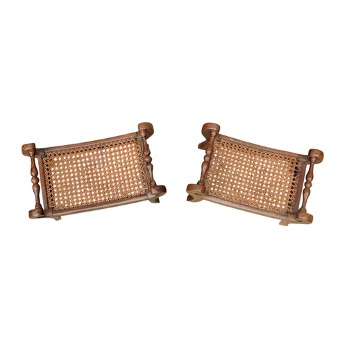 927 - A pair of 19th century mahogany footstools - the rectangular cane cushions between turned rails, on ... 