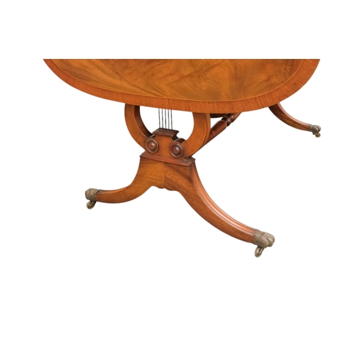 931 - A George III sytle mahogany sofa table - the rectangular top with drop ends, on lyre shaped end supp... 