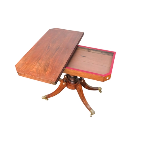 934 - A George IV rosewood card table - the rectangular top with canted corners, on a turned support and p... 