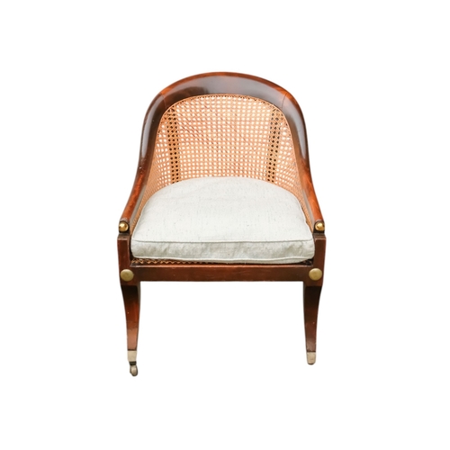 935 - A 19th century beech tub shaped bergere chair - with cane seat and back with a loose cushion, on squ... 