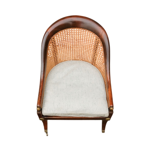 935 - A 19th century beech tub shaped bergere chair - with cane seat and back with a loose cushion, on squ... 