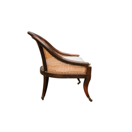 935 - A 19th century beech tub shaped bergere chair - with cane seat and back with a loose cushion, on squ... 