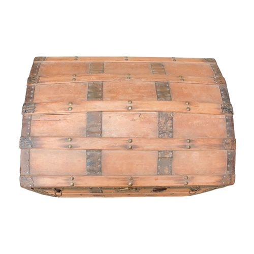 936 - An early 20th century beech and iron bound trunk - with a domed lid and laths, including iron fittin... 