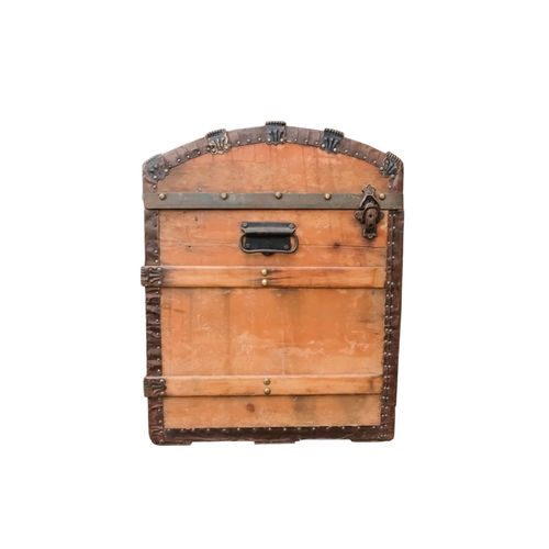 936 - An early 20th century beech and iron bound trunk - with a domed lid and laths, including iron fittin... 