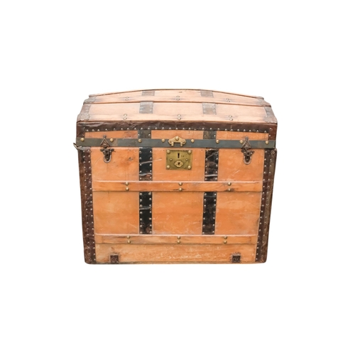 936 - An early 20th century beech and iron bound trunk - with a domed lid and laths, including iron fittin... 