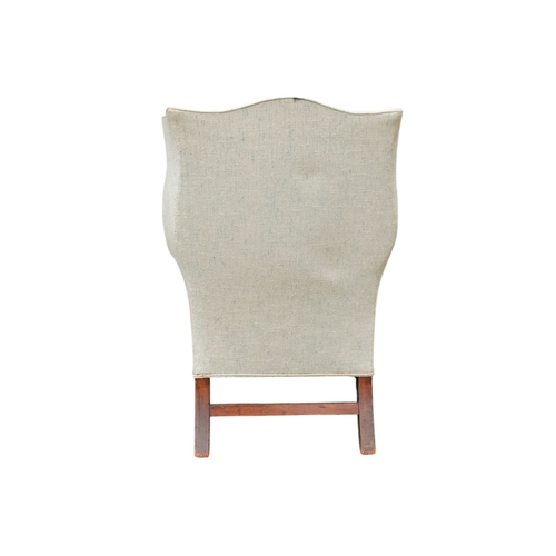 939 - A George III style mahogany wing armchair - light blue upholstery with a loose cushion seat, on squa... 