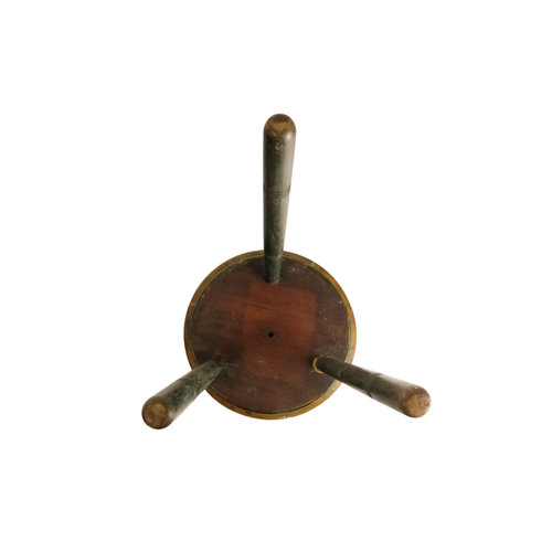 943 - A 19th century cricket stool - the circular seat painted with an iris, raised on three turned legs, ... 