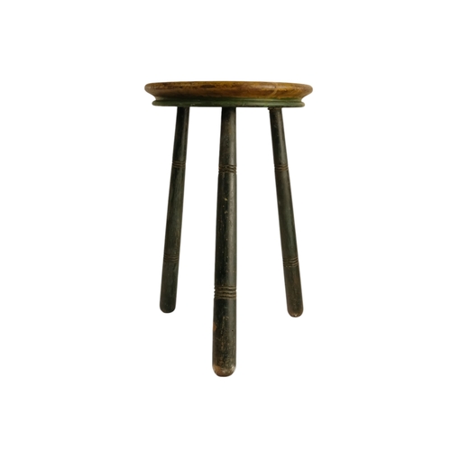943 - A 19th century cricket stool - the circular seat painted with an iris, raised on three turned legs, ... 