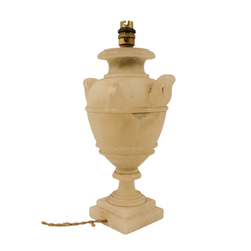 16 - A pair of early 20th century alabaster table lamps - of urn form with twin handles and raised on a s... 