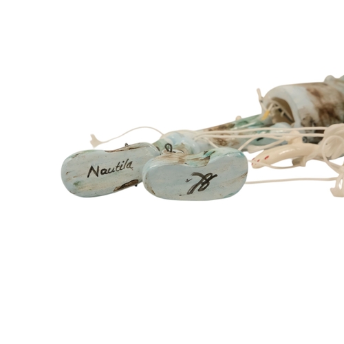 23 - A contemporary ceramic dancing doll - with horned head and articulated limbs, with a soft wood stand... 